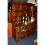 A REPRODUCTION OAK DRESSER, with a double plate rack and two drawers, width 130cm x depth 48cm x