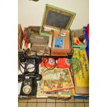 TWO RELIANCE BLACK BAKELITE TELEPHONES, together with two toy telephones and various games,