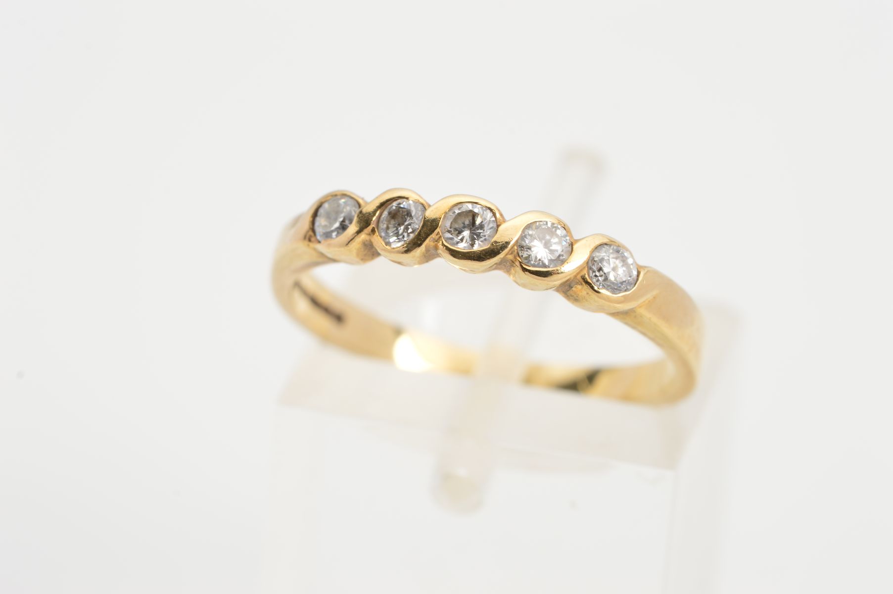 A 9CT GOLD FIVE STONE DIAMOND RING, designed as a row of five brilliant cut diamonds, estimated