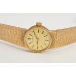 A 9CT GOLD LADIES LONGINES WRISTWATCH, gold coloured bark design dial with batons, 18mm round