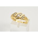 AN 18CT GOLD DIAMOND RING, designed as three diagonal rows each set with three graduated round