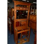 AN EARLY 20TH CENTURY OAK ART NOUVEAU HALL STAND, with a central mirror, various hooks and a