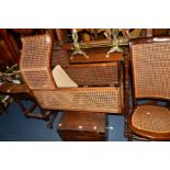 A VICTORIAN MAHOGANY AND STAINED BEECH AND CANED CRADLE, lancet arch shaped canopy with two turned