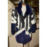 A DYED FOX FUR AND SUEDE JACKET, with dark blue suede lower arms, triangular panels of dyed blue