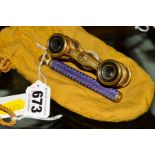 A PAIR OF LATE VICTORIAN/EDWARDIAN STYLE GILT METAL AND PURPLE ENAMEL OPERA GLASSES, marked