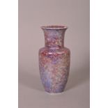 A RUSKIN POTTERY VASE, decorated with a mottled, iridescent lavender glaze, shape No.304 but on a