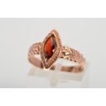 A 9CT GOLD RING, designed as a marquise shape red paste, with engraved detail to the surround and