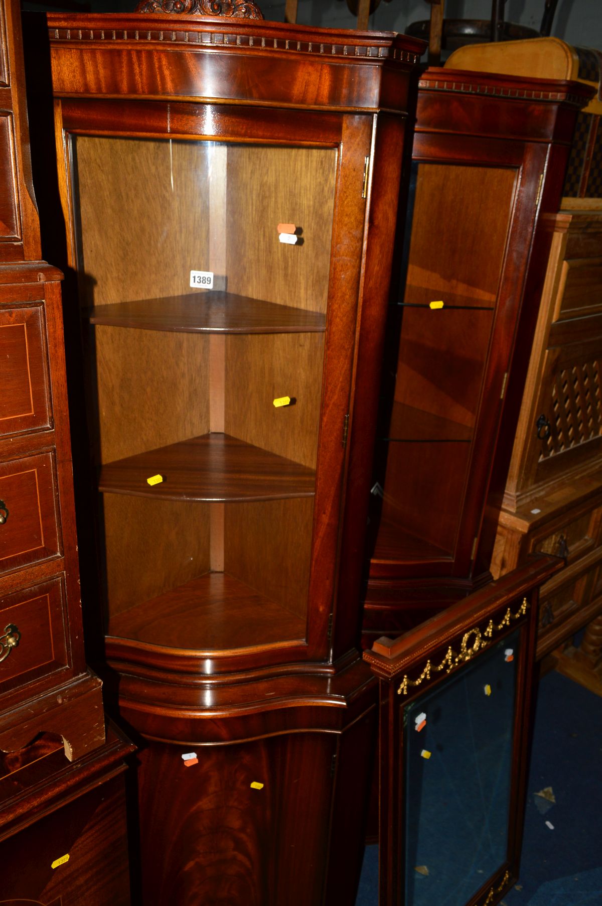 TWO REPRODUCTION MAHOGANY SERPENTINE CORNER CUPBOARDS, together with a mahogany double door