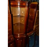TWO REPRODUCTION MAHOGANY SERPENTINE CORNER CUPBOARDS, together with a mahogany double door
