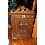 AN EARLY 20TH CENTURY CARVED MAHOGANY SMOKERS CABINET with two internal drawers