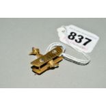 A WWI BRASS BI-PLANE SHAPED BROOCH, painted French flag to the tail and with moving propeller,