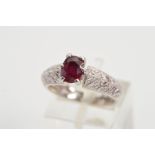 A RUBY AND DIAMOND DRESS RING, designed as an oval glass filled ruby within a six claw setting to