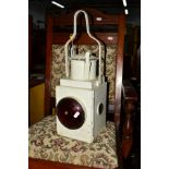 A VINTAGE WHITE PAINTED RAILWAY LAMP
