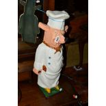 A VINTAGE PAINTED CAST IRON PIG dressed as a chef, height 58cm