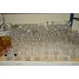 A COLLECTION OF CUT GLASS etc to include red and white wine glasses, port, sherry, whisky glasses,