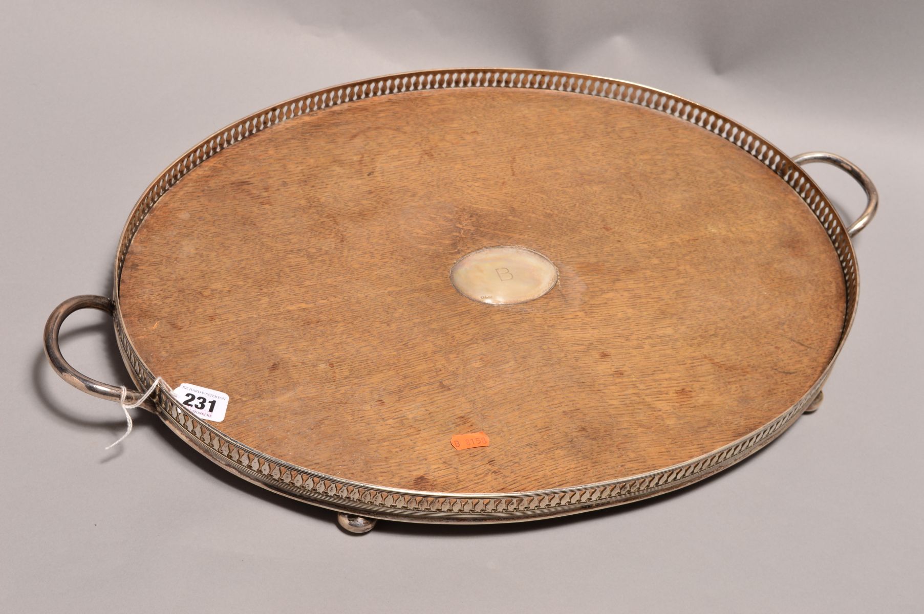 A LATE VICTORIAN SILVER MOUNTED OVAL OAK TWIN HANDLED GALLERY TRAY, the oak with oval silver