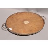 A LATE VICTORIAN SILVER MOUNTED OVAL OAK TWIN HANDLED GALLERY TRAY, the oak with oval silver