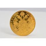 A GOLD FOUR DUCAT AUSTRIAN COIN, slightly bent, .986, 13.96 grams, 1915