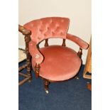 AN EDWARDIAN WALNUT TUB CHAIR on fluted legs covered in pink upholstery