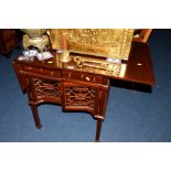 A REPRODUCTION MAHOGANY DROP LEAF SIDE TABLE, with a fretwork perimeter, two doors and a single