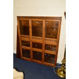 AN EARLY 20TH CENTURY OAK BOOKCASE OF GLOBE WERNICKE STYLE, three sections each with three glazed
