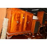 TWO MAHOGANY DOUBLE DOOR CABINETS, together with a pair of matching speaker cabinets (4)