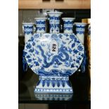 AN ORIENTAL BLUE AND WHITE TULIP VASE, decorated with a Dragon (five claws) on either side, with