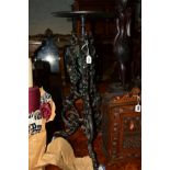 A PAINTED CAST IRON TORCHERE STAND on triple legs with foliate decoration, height 77cm