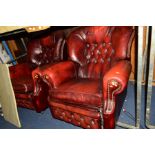 A PAIR OF OX BLOOD RED LEATHER BUTTON BACK RECLINING ARMCHAIRS together with a marble top (3)