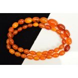 A NATURAL AMBER NECKLACE, designed as graduated oval shape beads measuring 8mm to 16mm, to the screw