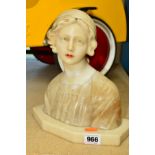 AN EARLY 20TH CENTURY ALABASTER BUST OF A CONTINENTAL FEMALE FIGURE, signed Guioli to the reverse,