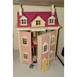 A MODERN THREE STOREY DOLL'S HOUSE AND FURNISHINGS, with pink pitch roof and pink finish,