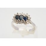 A SAPPHIRE AND DIAMOND CLUSTER RING, designed with three central oval sapphires with single cut