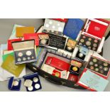 A SUITCASE CONTAINING YEAR PROOF SETS, many proof silver coins, to include seventeen Royal Mint year