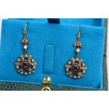 A PAIR OF GARNET, DIAMOND AND SPLIT PEARL DROP EARRINGS, each with a circular garnet cabochon within