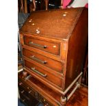 AN OAK BUREAU with three drawers, together with a blue painted Lloyd Loom bedroom chair and linen