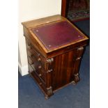 A VICTORIAN ROSEWOOD DAVENPORT, the hinged slope with tooled leather front and four drawers to the