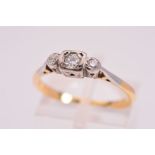 A DIAMOND THREE STONE RING, designed with a central old cut diamond flanked by brilliant cut