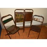 A NEAR SET OF FOUR METAL FOLDING CHAIRS, two with embossed lettering to seat/back, possibly from