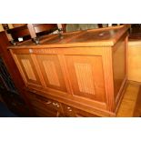 A LIGHT OAK LINENFOLD TRIPLE PANEL BLANKET CHEST