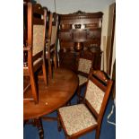 AN OLD CHARM OAK DROP LEAF DINING TABLE and six chairs including two carvers, together with a