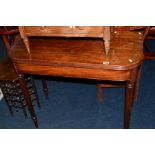 A GEORGIAN MAHOGANY FOLD OVER TEA TABLE on fluted legs