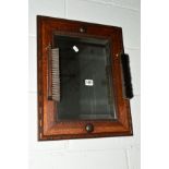 AN EARLY 20TH CENTURY OAK WALL MIRROR with a pair of loose hanging brushes (3)