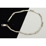 A 9CT WHITE GOLD CUBIC ZIRCONIA BRACELET, each link designed as a row of four circular cubic