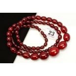 A BAKELITE BEAD NECKLACE, designed as barrel shape beads measuring 7mm to 24mm, to the screw