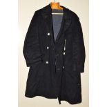 AN L.M.S. RAILWAY OVERCOAT, black woollen overcoat with Harris tweed lining, six L.M.S. buttons to
