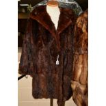 A MUSQUASH FUR JACKET, with lapel collar, two hook fasteners, inner ribbon tie, length from neckline