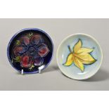 TWO SMALL MOORCROFT POTTERY PIN DISHES, 'Anemone' on blue ground and the other with single leaf on