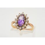 AN AMETHYST AND SEED PEARL CLUSTER RING, the central oval amethyst within a split pearl surround