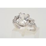 A 9CT WHITE GOLD RING, designed with a central rectangle cut cubic zirconia, the shoulders with